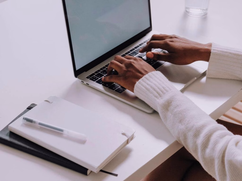 Person on laptop working on content writing and copywriting.