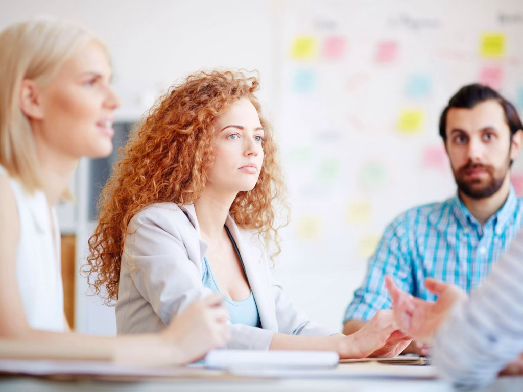 Persons discussing the creative brief.