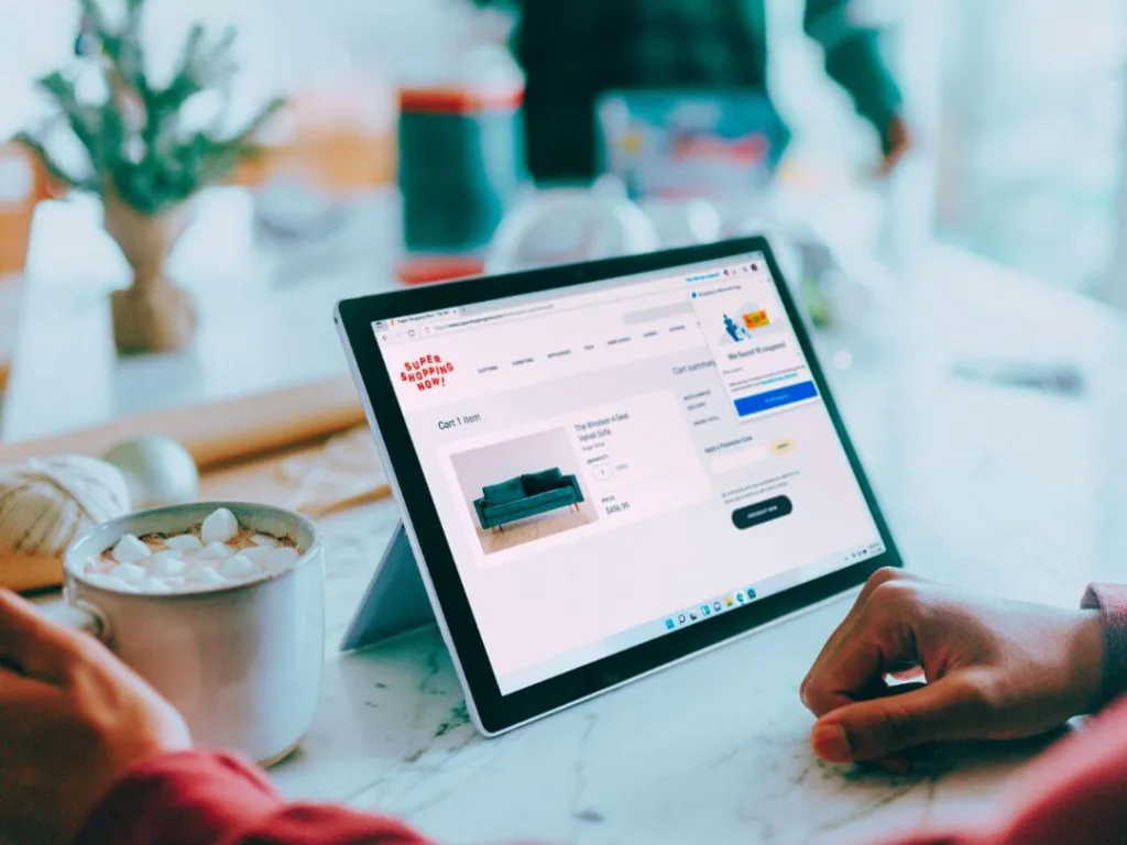 Person on tablet working on a magazine page layout design.
