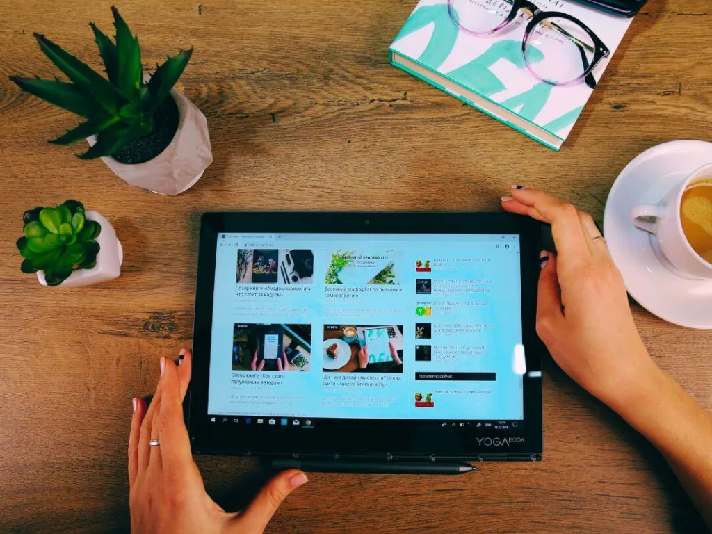 Person on tablet working on brand management.