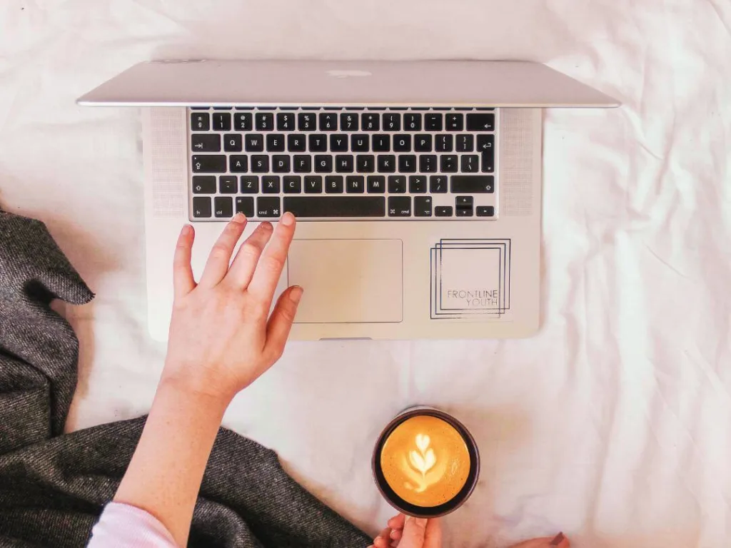Person on laptop working on brand management.