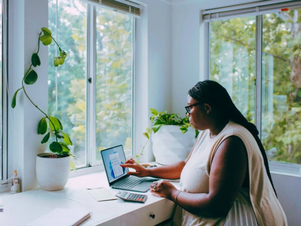 Person on laptop working on a content creation calendar.
