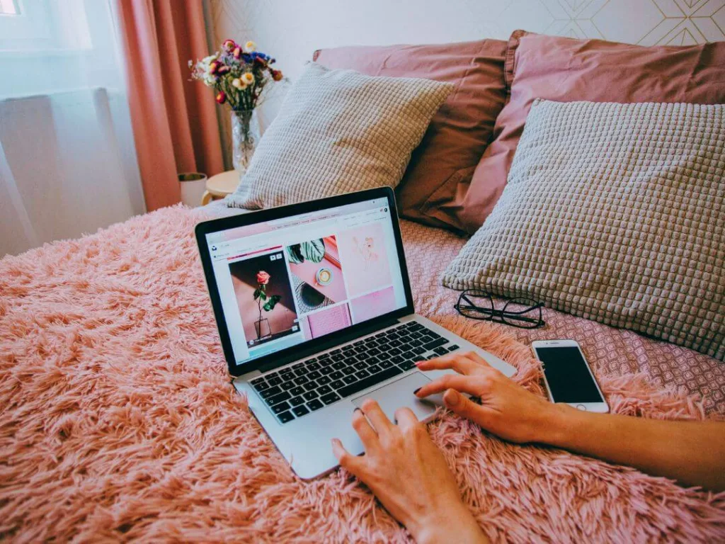 Person on laptop working on a content creation calendar.