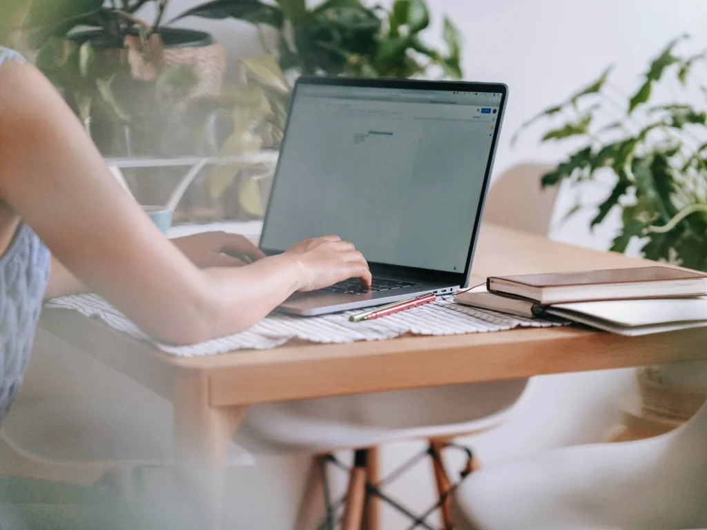 Person using laptop to work on AI-powered lead generation.