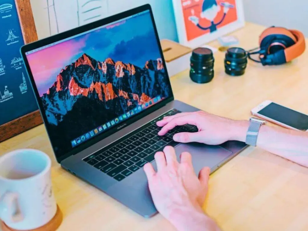 Person on laptop working on a social media strategy.