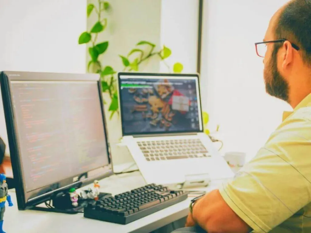 Person on laptop working on a social media strategy.