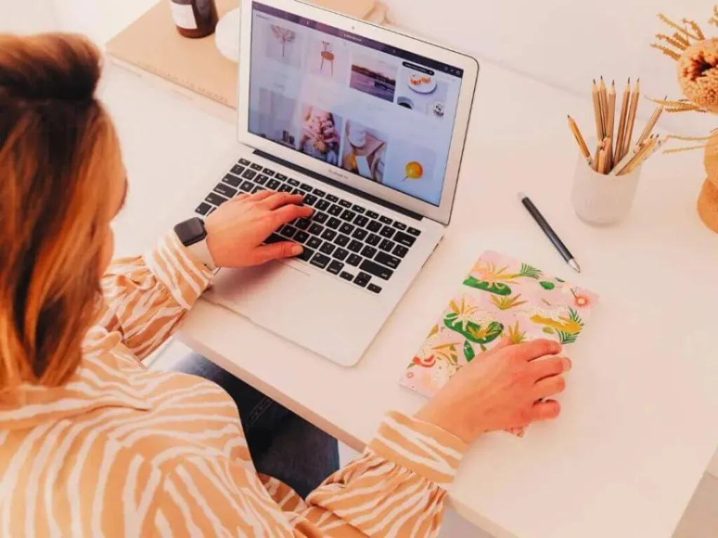 Person on laptop working on a social media strategy.