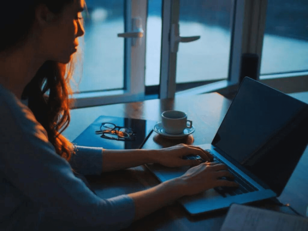 Person on laptop learning about CRM.