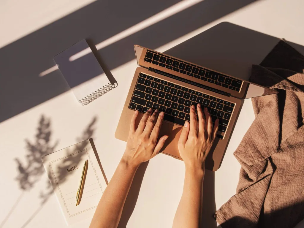 Person on laptop working on Pinterest Marketing.